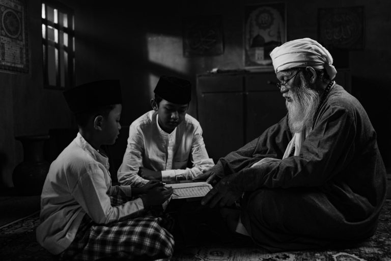 Elder and children engage in a traditional Islamic teaching session, fostering cultural and educational values.